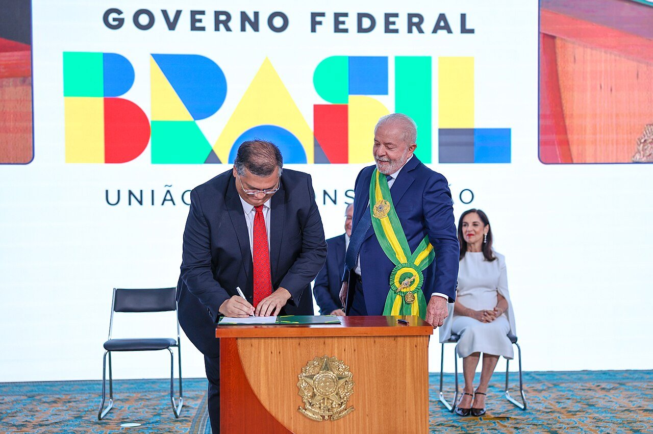 Flávio Dino assina o termo de posse como ministro da Justiça ao lado do presidente Lula, em 1º de janeiro de 2023, no Palácio do Planalto