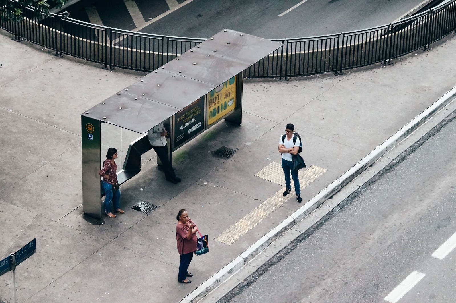 Pessoas esperam em ponto de ônibus visto do alto, em foto de arquivo de uma capital brasileira